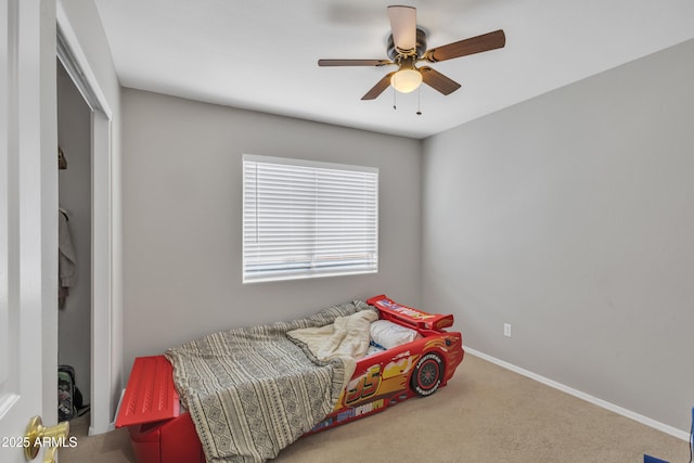 bedroom featuring a closet, baseboards, a ceiling fan, and carpet floors