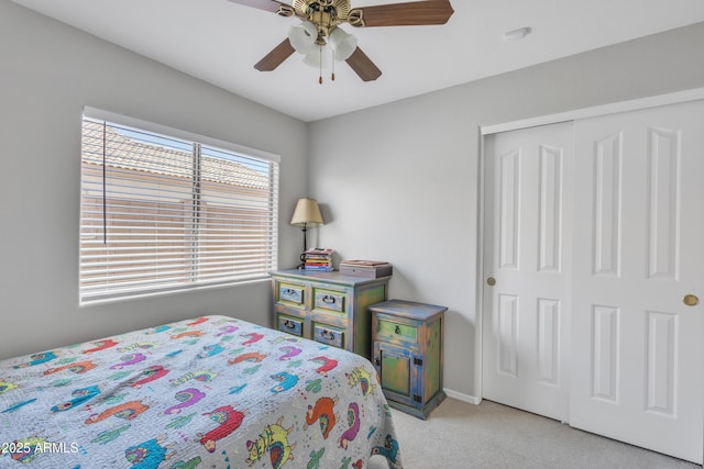 bedroom featuring light carpet, a closet, ceiling fan, and baseboards