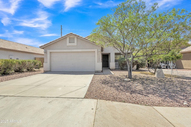 ranch-style house with concrete driveway, an attached garage, a tile roof, and stucco siding