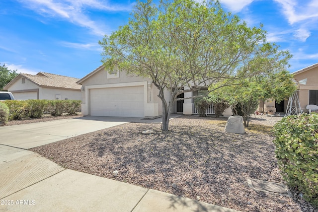 view of front of house featuring a garage, a tile roof, driveway, and stucco siding