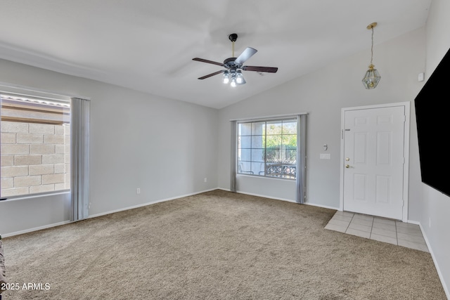 entrance foyer featuring baseboards, a ceiling fan, carpet flooring, and vaulted ceiling