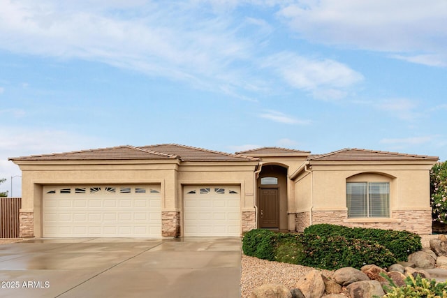 view of front of home with an attached garage, stone siding, and driveway