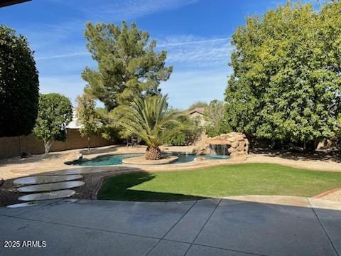 view of yard with a patio, a fenced backyard, and an outdoor pool