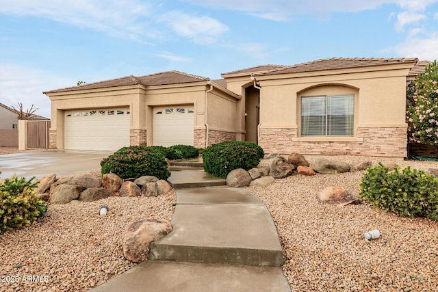 view of front of house featuring a garage, stone siding, concrete driveway, and stucco siding