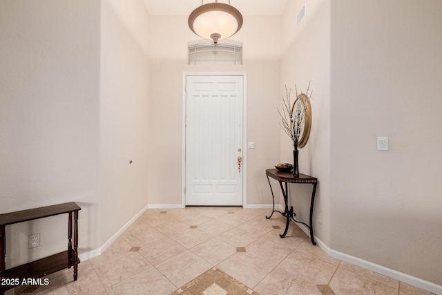 entrance foyer with light tile patterned floors, visible vents, and baseboards