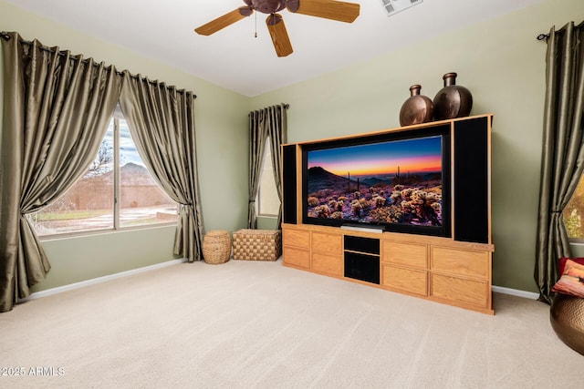 interior space with light carpet, visible vents, a ceiling fan, and baseboards