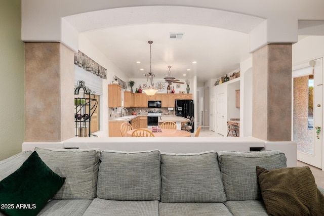 living room featuring visible vents and recessed lighting