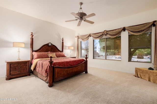 bedroom featuring carpet floors, multiple windows, and a ceiling fan