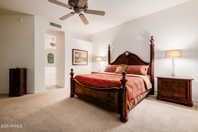 carpeted bedroom featuring baseboards, visible vents, ceiling fan, and connected bathroom