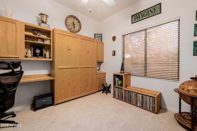 office space with lofted ceiling, light colored carpet, ceiling fan, and built in study area