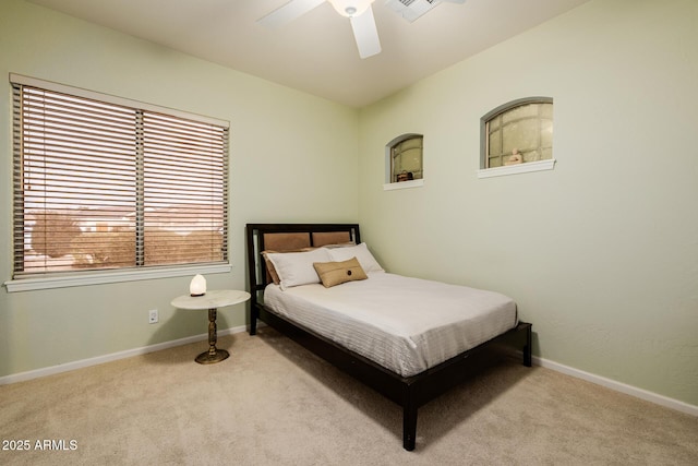 carpeted bedroom with ceiling fan and baseboards