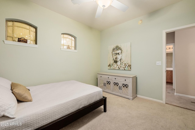 carpeted bedroom with ceiling fan and baseboards