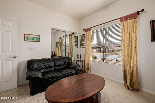 living area featuring carpet floors and baseboards