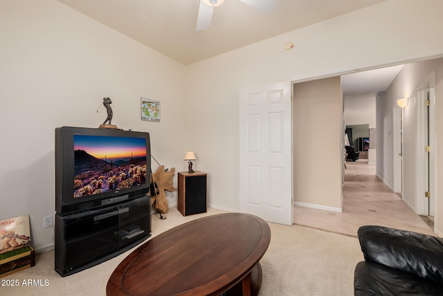 living room featuring ceiling fan, baseboards, and carpet flooring