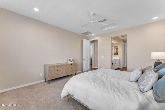 carpeted bedroom with ceiling fan and ensuite bath