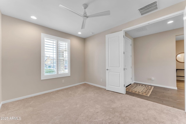 carpeted empty room with ceiling fan