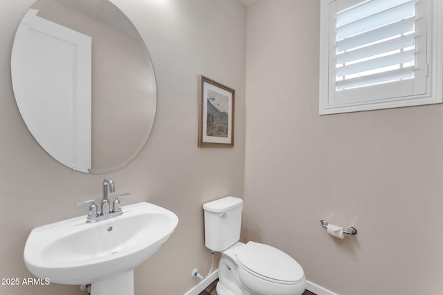 bathroom featuring sink and toilet