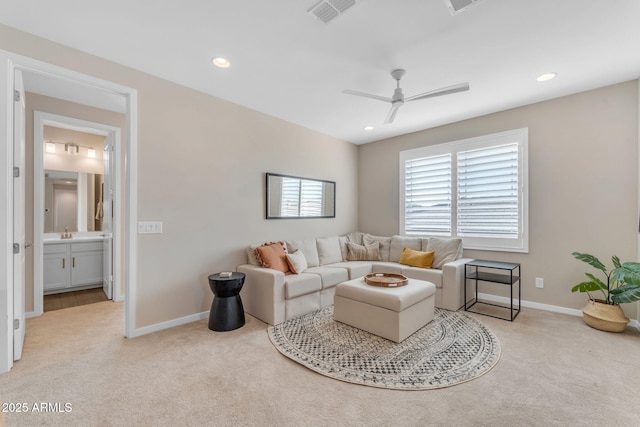 living room with ceiling fan and light carpet