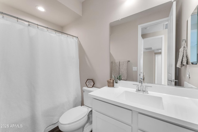 bathroom featuring vanity and toilet