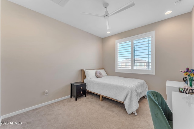 bedroom with ceiling fan and light carpet