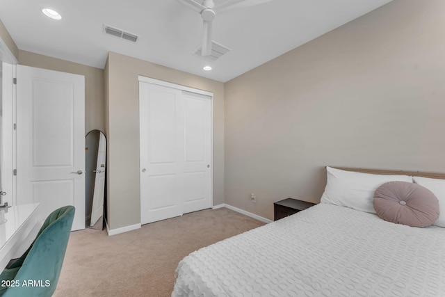 bedroom featuring light carpet, a closet, and ceiling fan