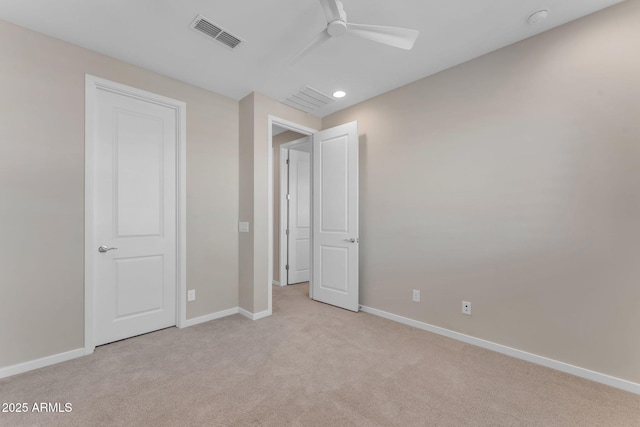 unfurnished bedroom with light carpet and ceiling fan