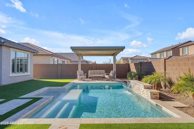 view of pool with pool water feature and outdoor lounge area