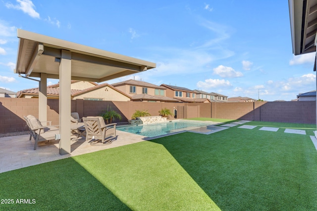 view of yard featuring pool water feature, a fenced in pool, and a patio area