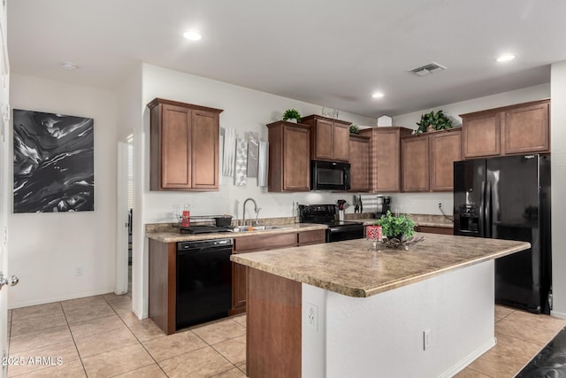 kitchen with light tile patterned flooring, sink, a kitchen island, and black appliances