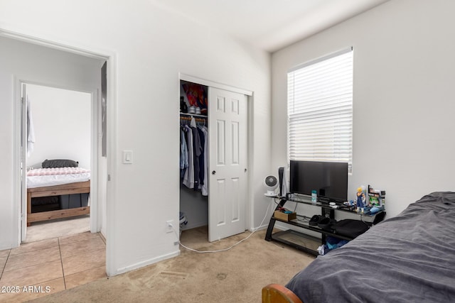 bedroom with a closet and light carpet