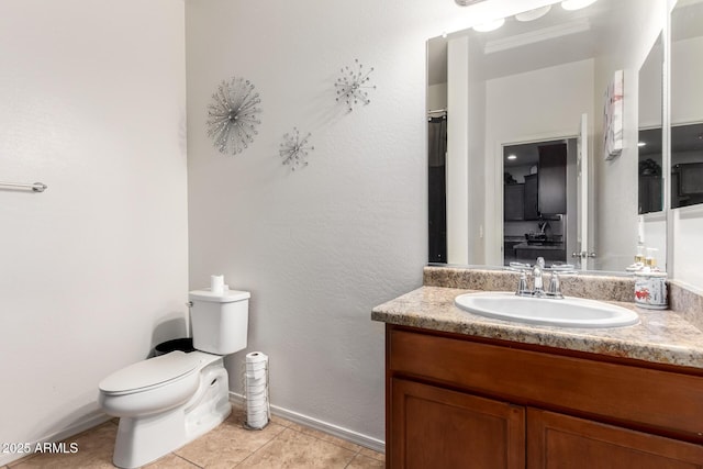 bathroom with vanity, tile patterned flooring, and toilet