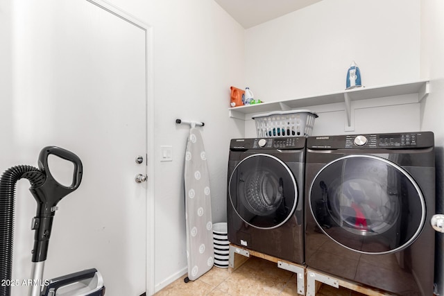 washroom with light tile patterned flooring and washing machine and clothes dryer