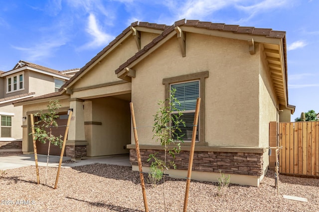 view of front of home with a garage and a patio