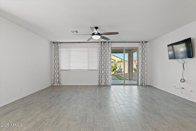 empty room with light wood-type flooring and ceiling fan