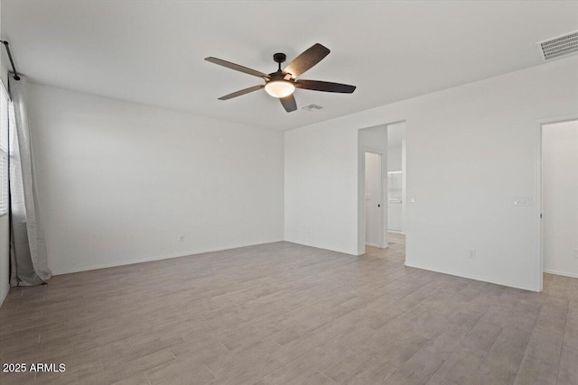 spare room featuring ceiling fan and light hardwood / wood-style floors