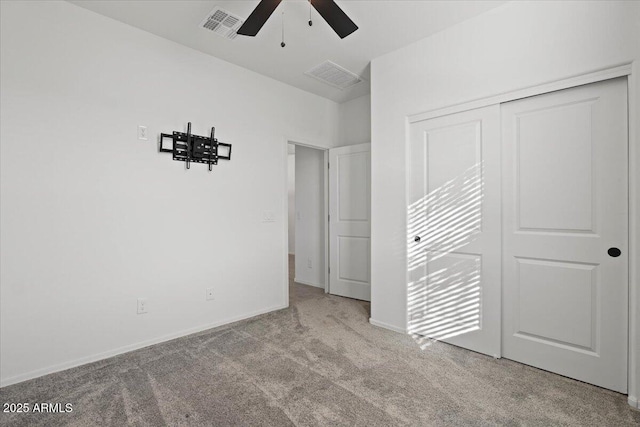 unfurnished bedroom featuring ceiling fan, light colored carpet, and a closet