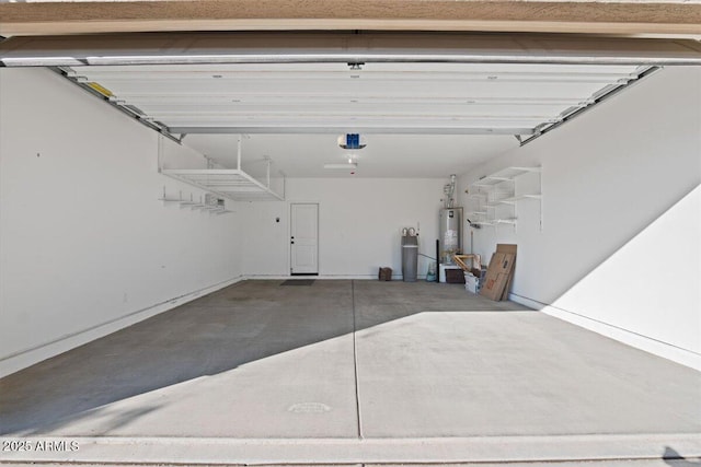 garage with a garage door opener and gas water heater