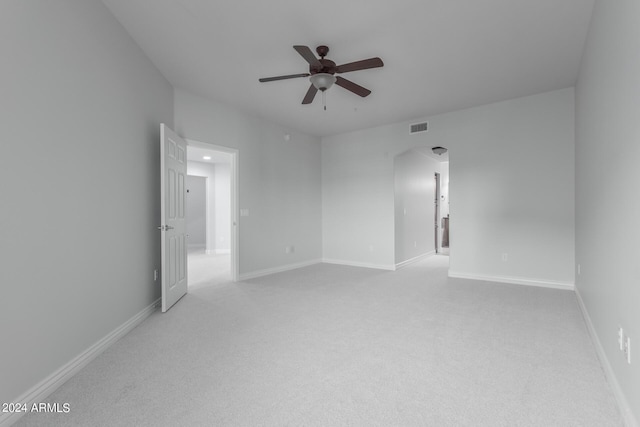 carpeted spare room with ceiling fan