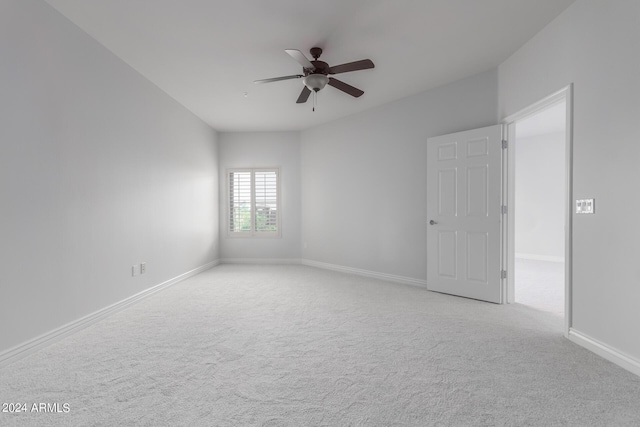 unfurnished room with ceiling fan and light colored carpet