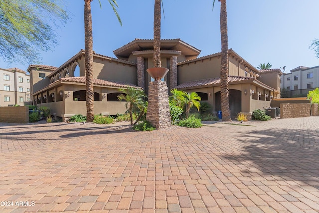 mediterranean / spanish-style house with central air condition unit