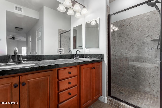 bathroom with ceiling fan, an enclosed shower, vanity, and tile patterned flooring