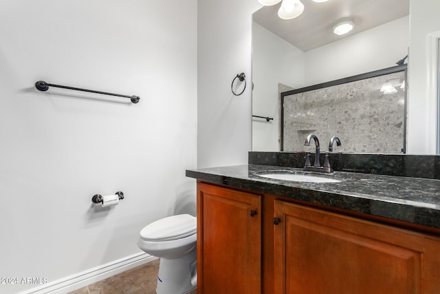 bathroom featuring a shower with shower door, vanity, tile patterned flooring, and toilet