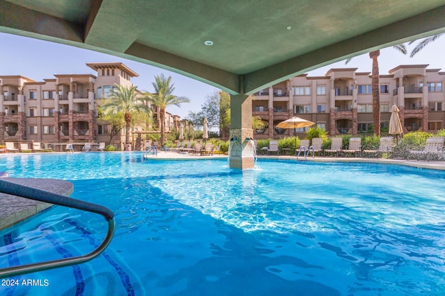 view of swimming pool with pool water feature