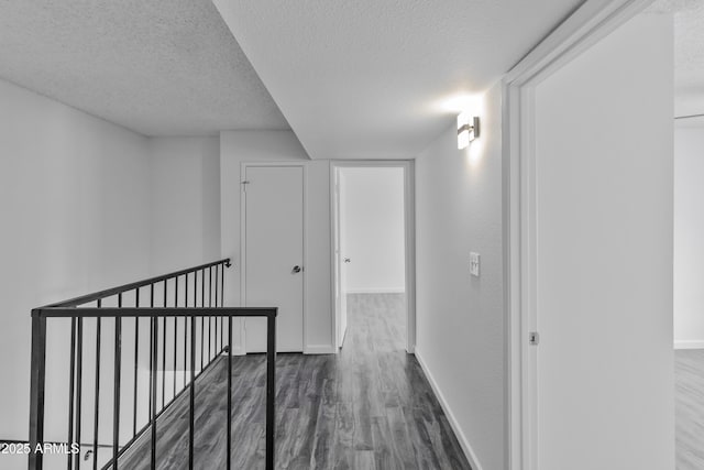 hall featuring dark hardwood / wood-style floors and a textured ceiling