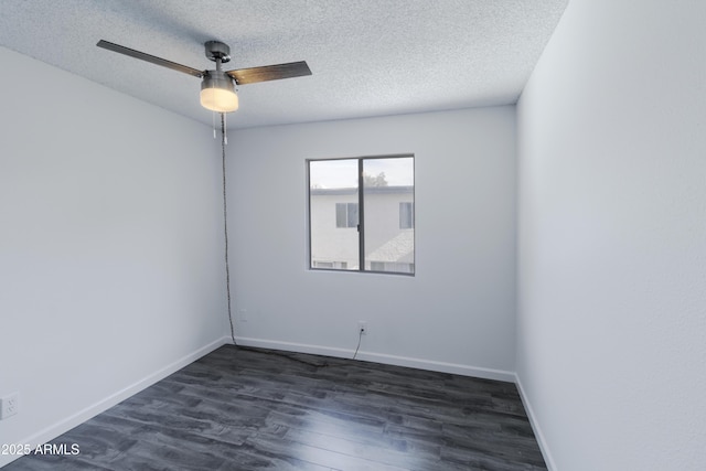 empty room featuring ceiling fan, dark hardwood / wood-style flooring, and a textured ceiling