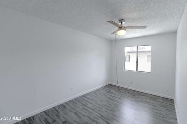 empty room featuring hardwood / wood-style flooring, a textured ceiling, and ceiling fan