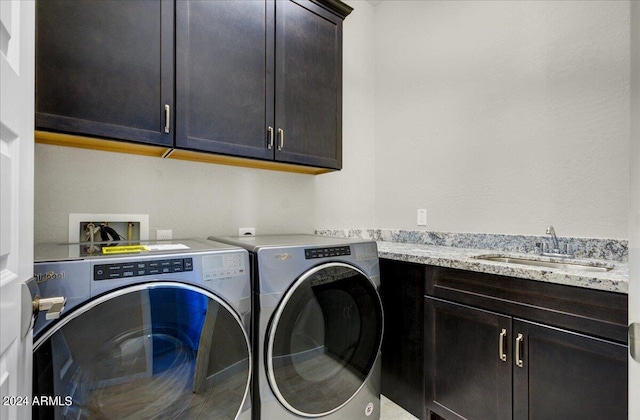 laundry area with cabinets, separate washer and dryer, and sink