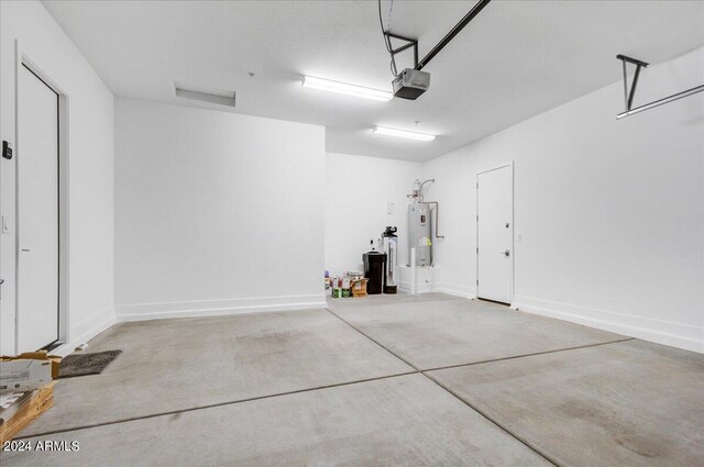 garage with electric water heater and a garage door opener