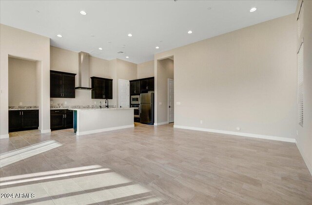 unfurnished living room featuring sink