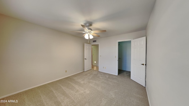 unfurnished bedroom featuring ceiling fan and light colored carpet